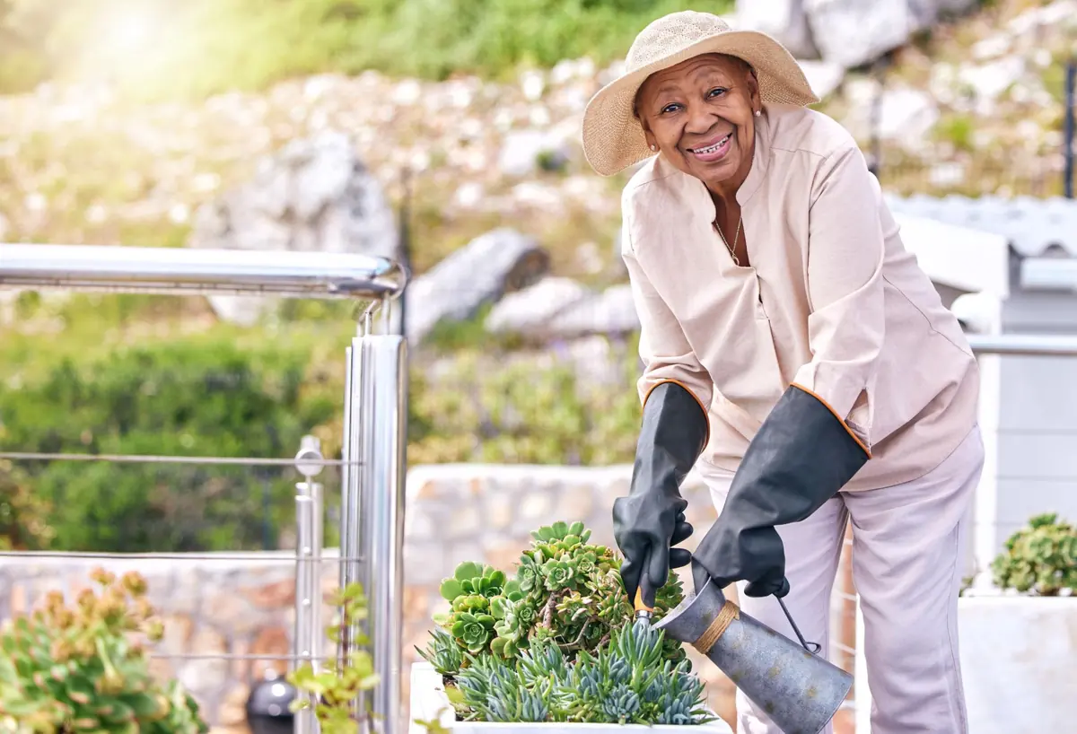 A woman watering plants on her terrace