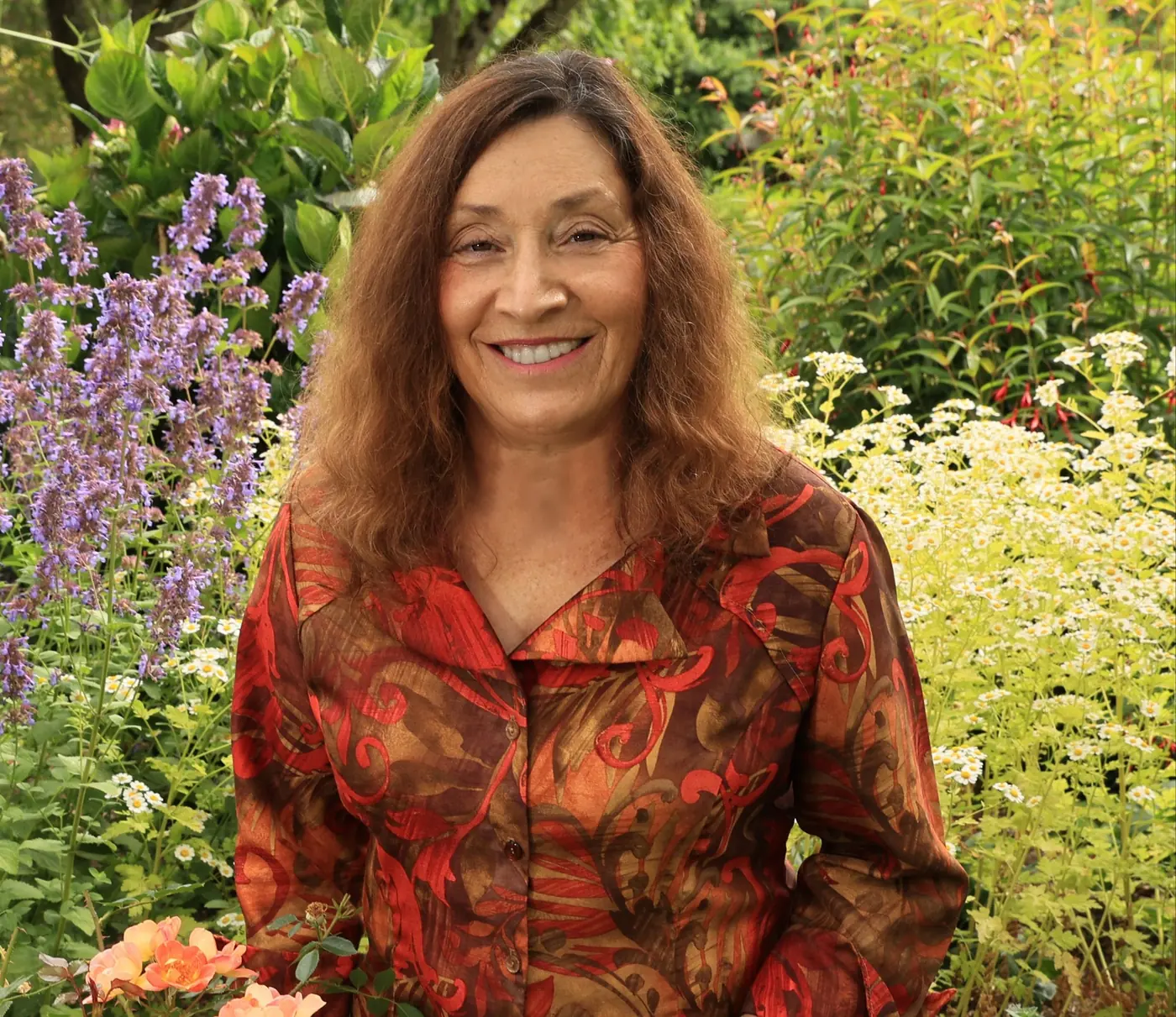 Dr. Laara Van Bryce in a Pacific Northwest garden among lavender and summer flowers