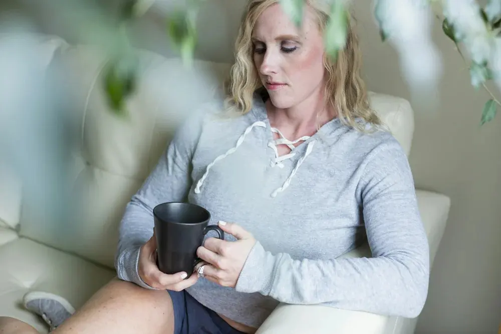 A woman relaxing at home with a warm drink